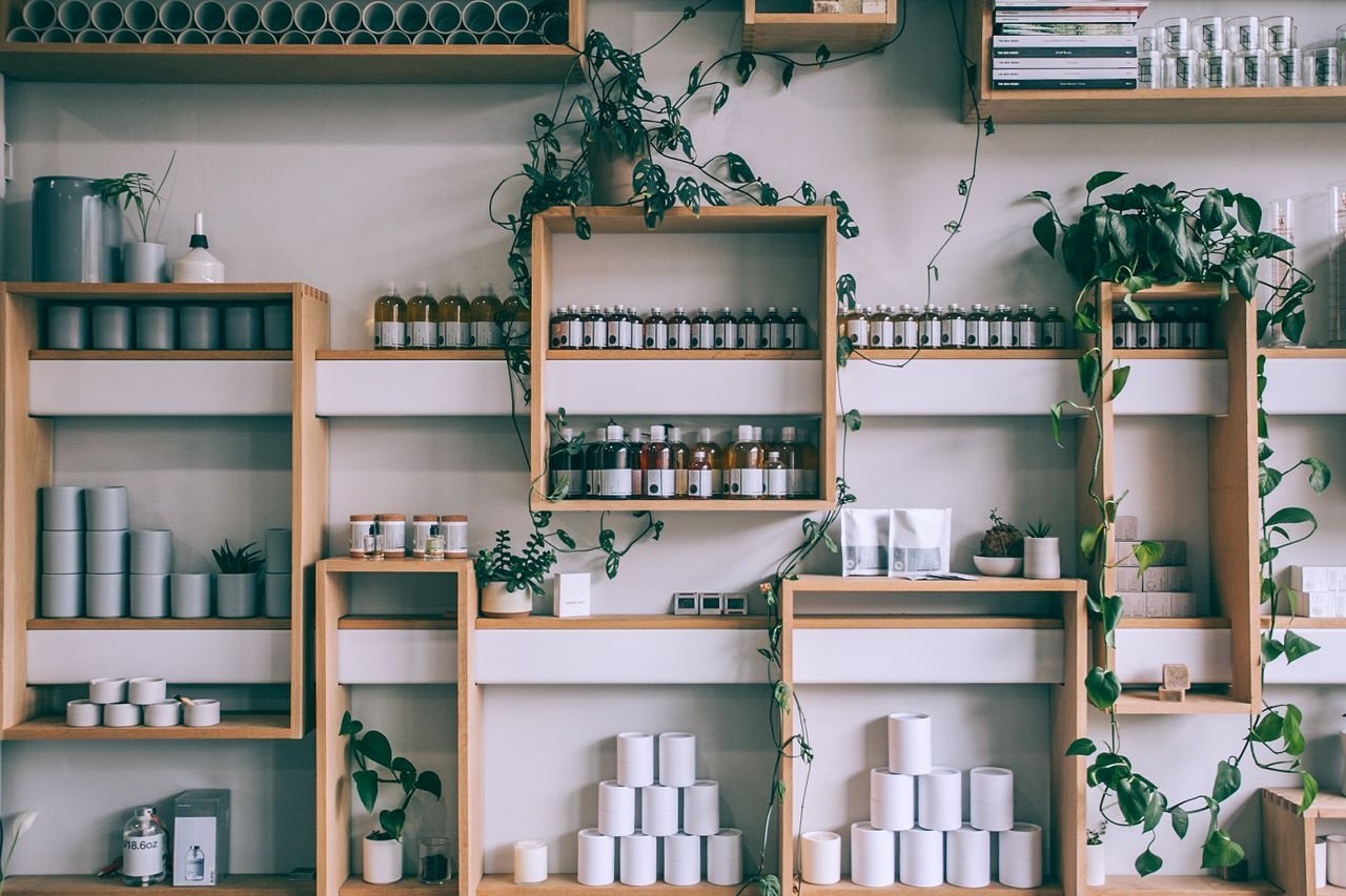 social-feed-img-03 Creative interior design of small shop with wooden shelves full of assorted colorful bottles and green plants